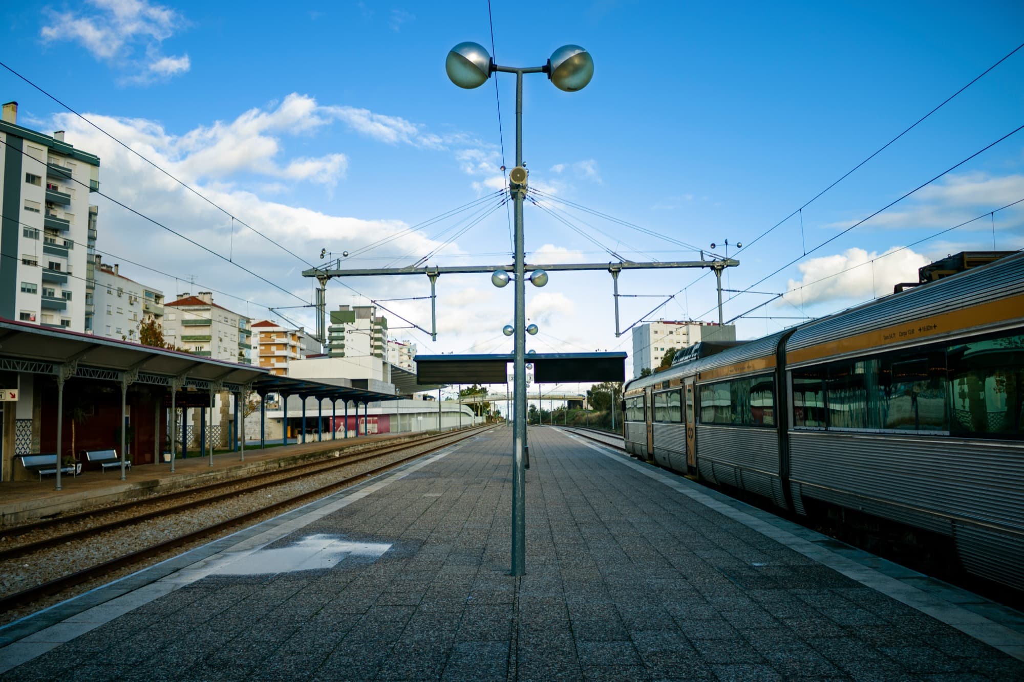 modern transit station platform with arriving train